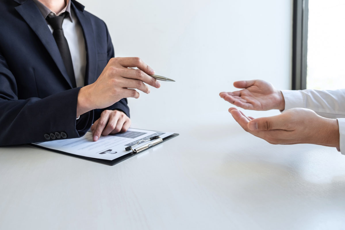 People's hands at a business interview